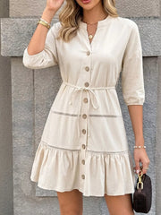 Apricot cotton V-neck buttoned mini dress with ruffle hem and tie waist.