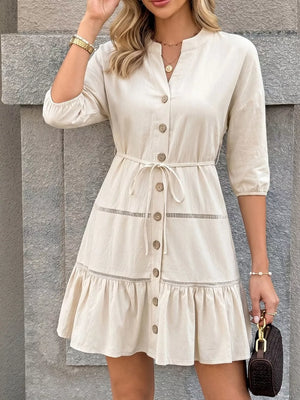 Apricot cotton V-neck buttoned mini dress with ruffle hem and tie waist.