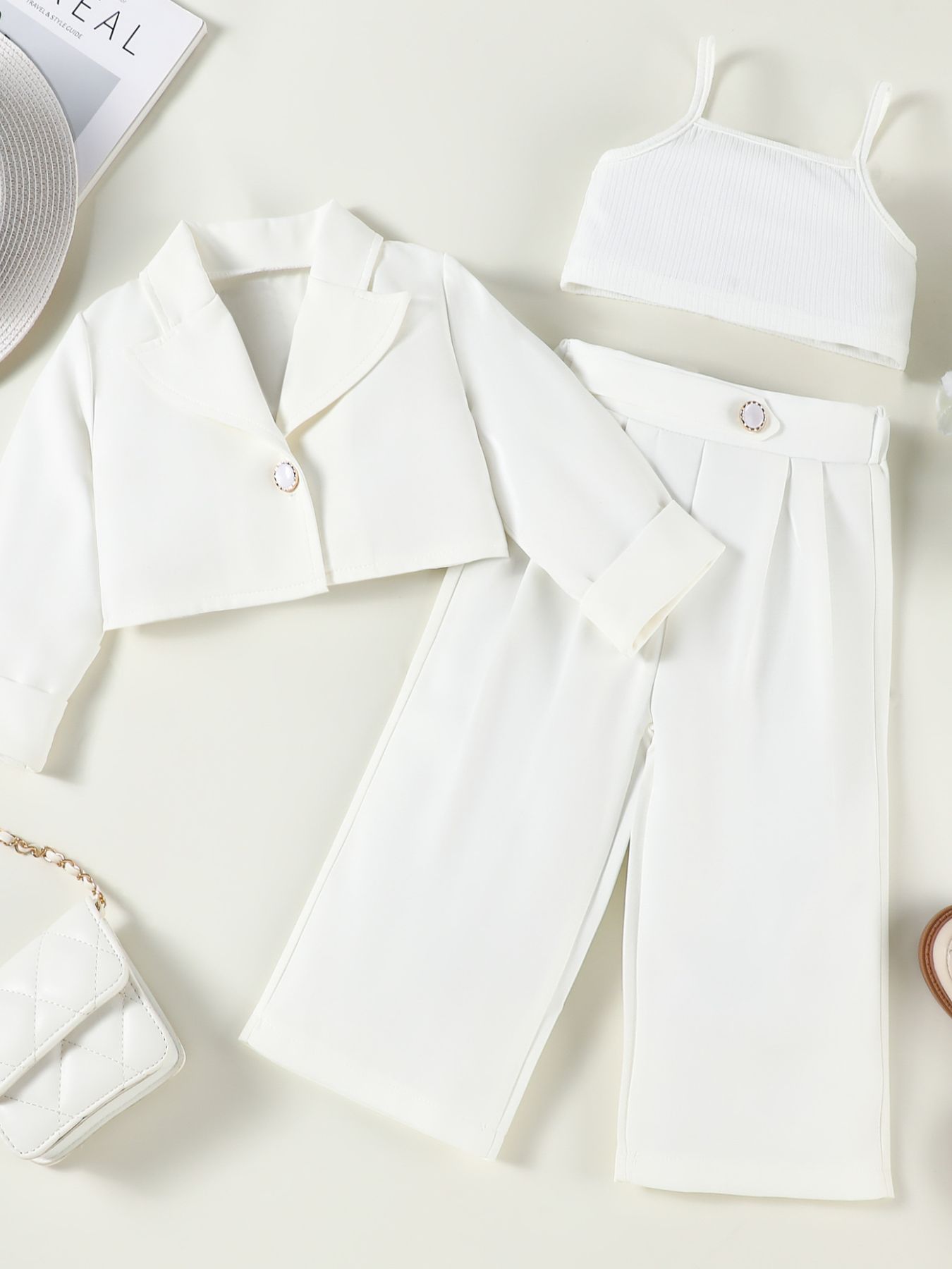 Toddler white three-piece blazer set with cropped jacket, cami, and wide-leg pants.