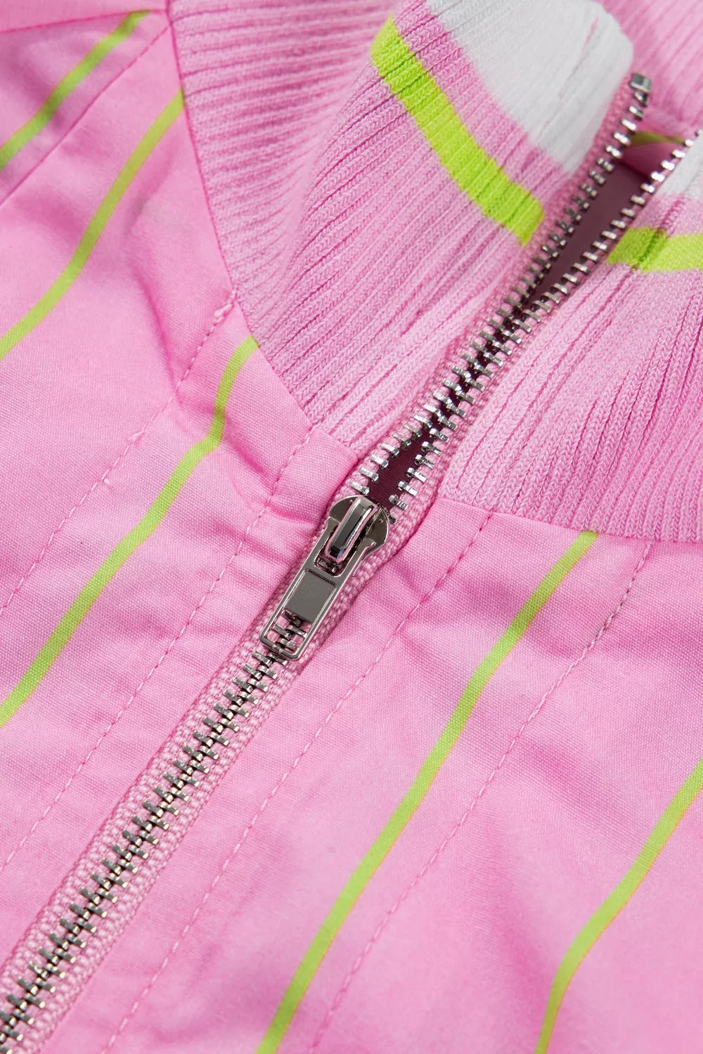Pink striped half-zip polo shirt with a ribbed collar and white and lime green stripes.