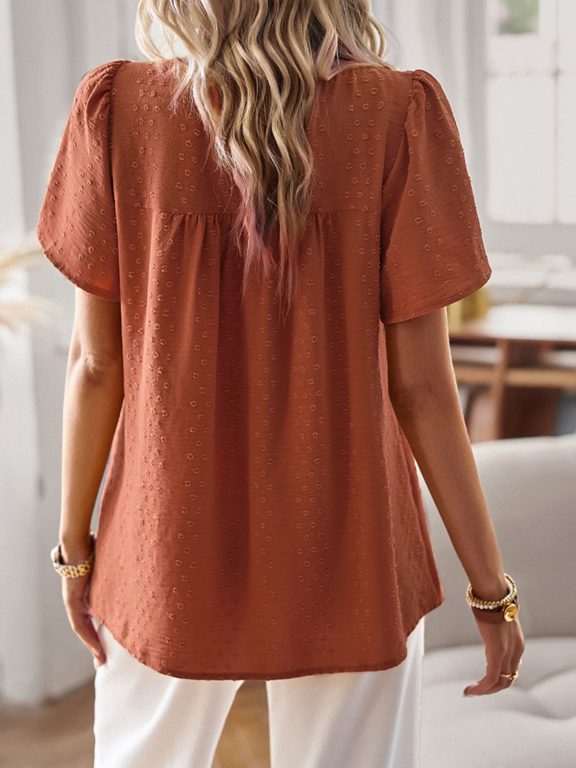 Textured puff sleeve yoke top in terracotta with short sleeves and a gathered yoke detail.