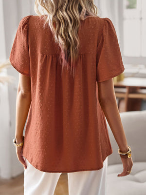 Textured puff sleeve yoke top in terracotta with short sleeves and a gathered yoke detail.