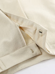 Buttoned vest and shorts set in natural cotton with zipper and button closure details.