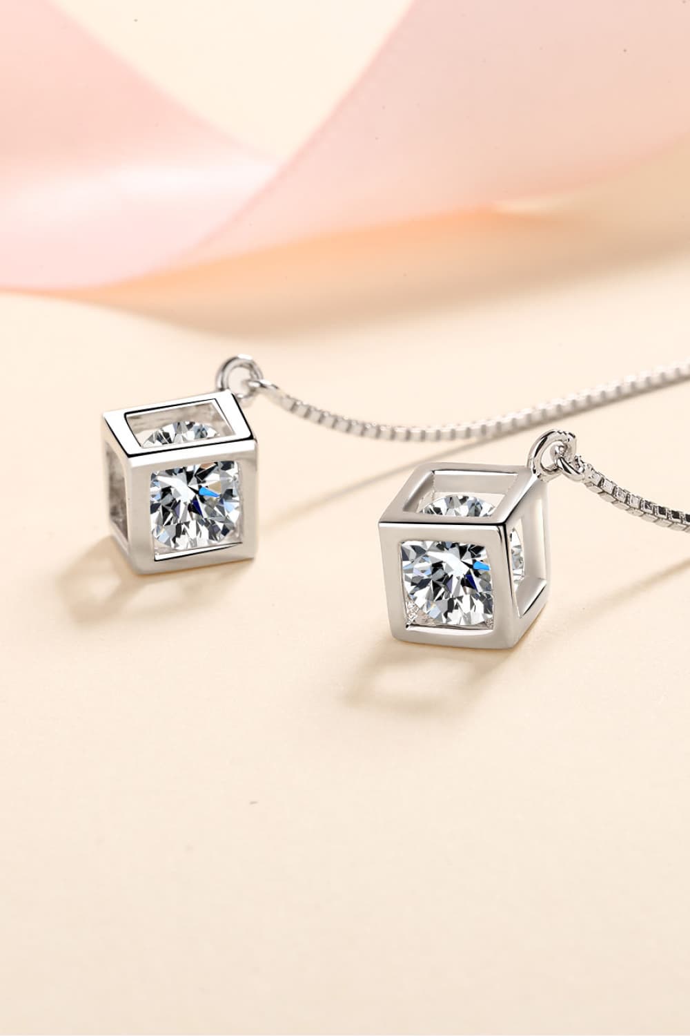 Silver geometric cube threader earrings with clear cubic zirconia stones.