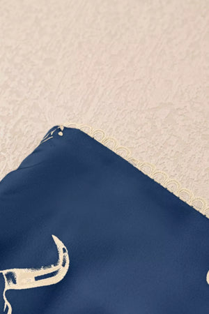 Navy satin maxi skirt with white western-inspired print and scalloped trim.