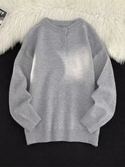 Light gray ribbed knit sweater with button detail at the neckline.