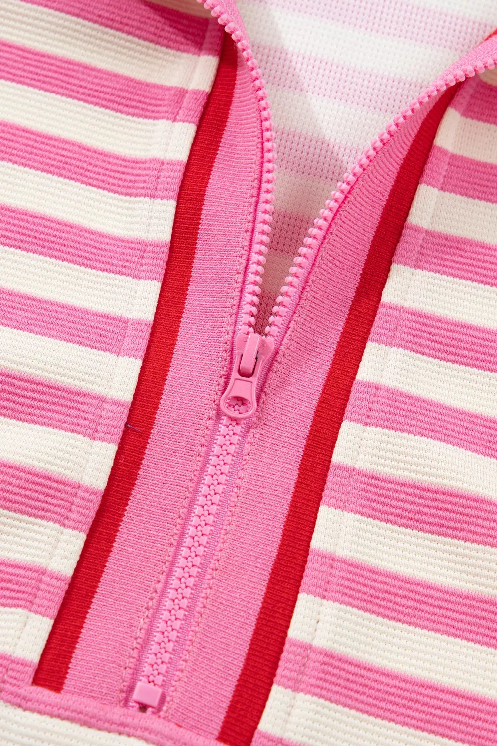 Pink and white striped cotton bikini top with a pink half-zip and red trim.