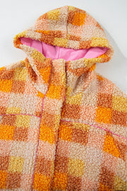 Checkerboard sherpa hooded jacket in tangerine with pink contrast stitching and lining.