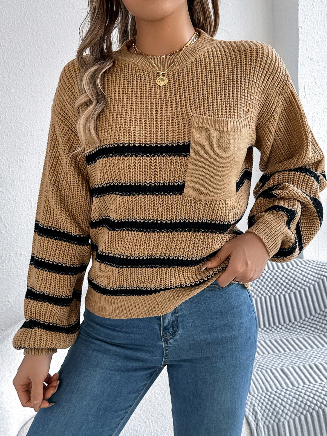Caramel knit sweater with black stripes, crew neck, long sleeves, and a chest pocket.
