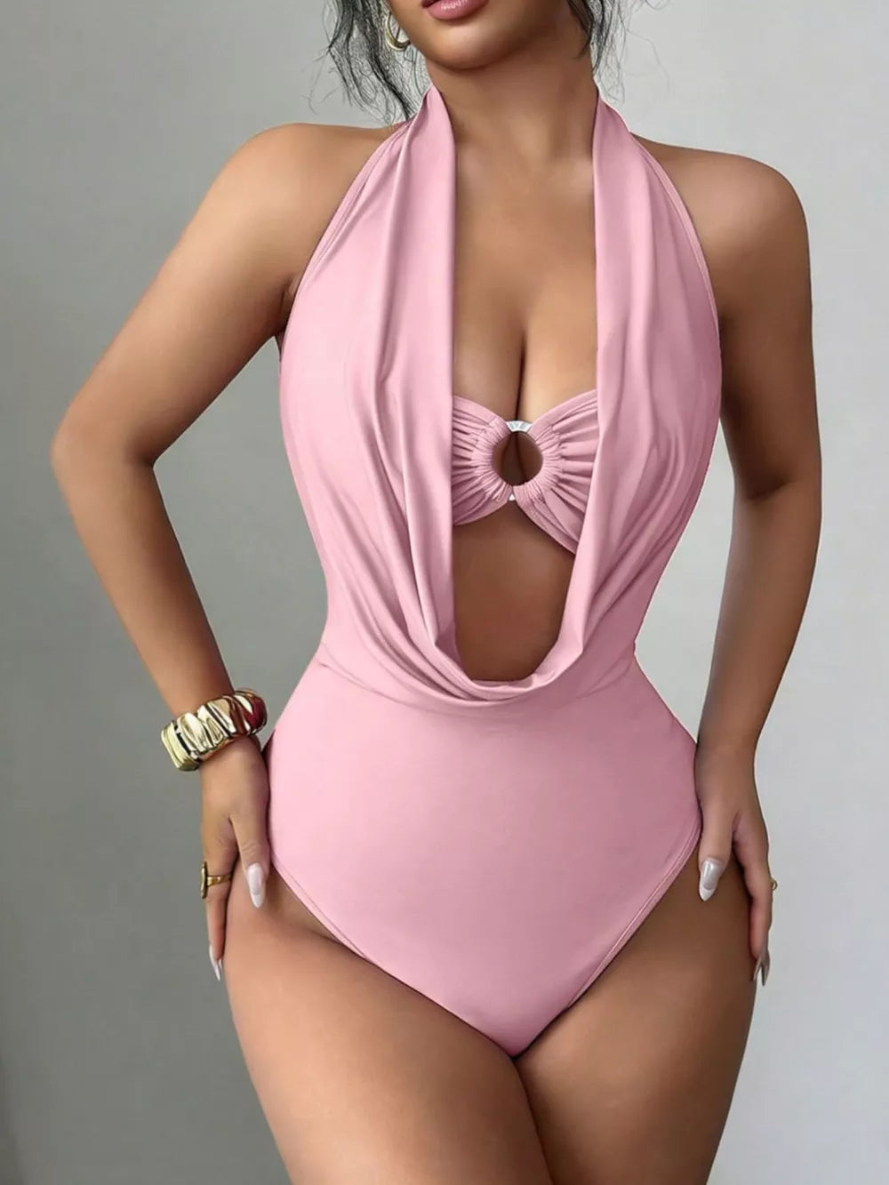 Pink halter neck cutout ruched bodysuit with a ring detail at the bust.