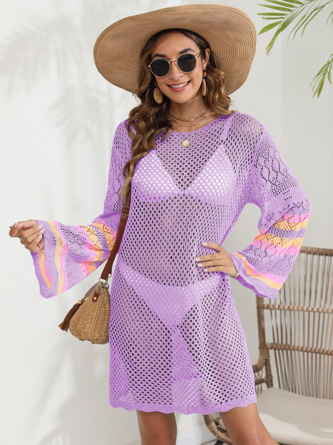 Purple crochet cover-up with bell sleeves featuring colorful stripes, worn over a bikini.