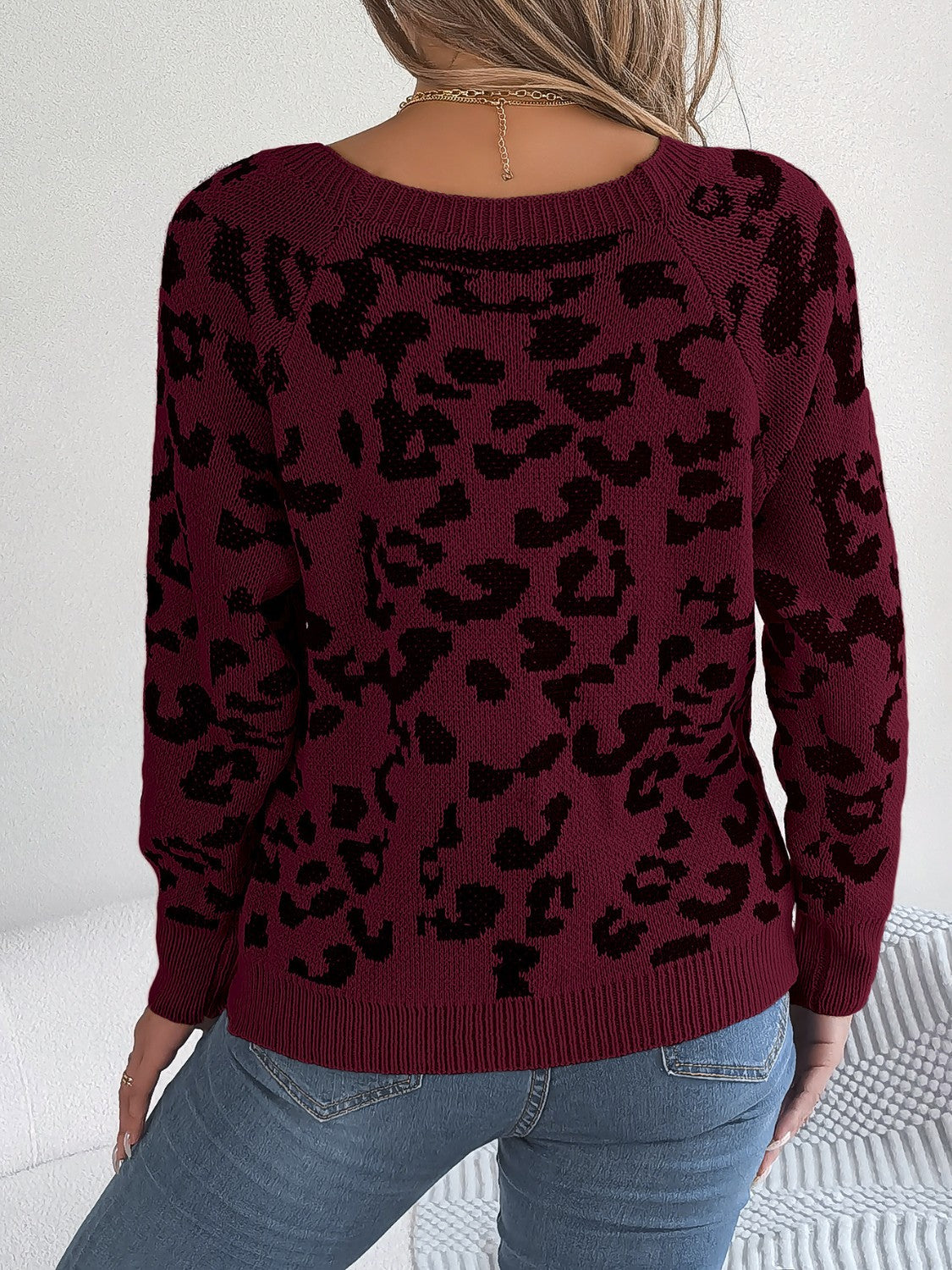 Wine leopard print acrylic sweater with button detail and crew neck.