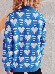 Blue acrylic knit jumper with white geometric heart pattern, crew neck, long sleeves.
