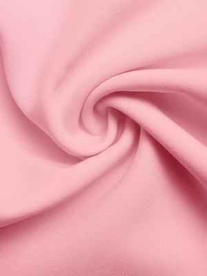 Pink fabric detail with soft folds and subtle texture.