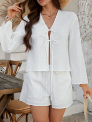 White linen tie-front top and shorts set with bell sleeves and drawstring waist.