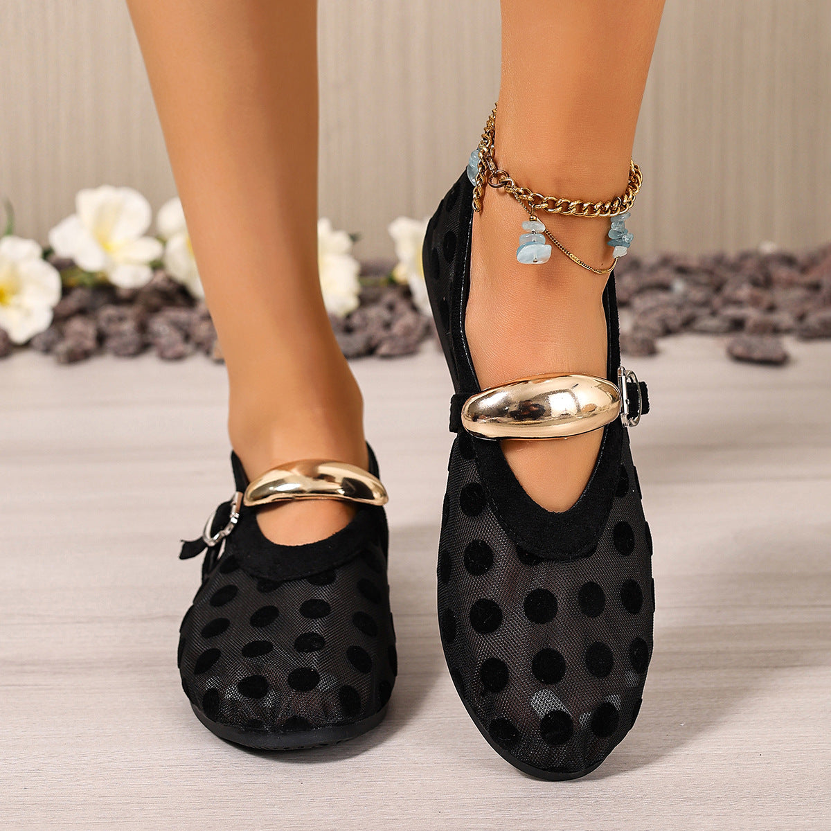 Black polka dot mesh slip-on flats with gold buckle detail and anklet.