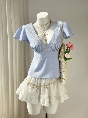 Blue striped polyester blouse with lace V-neck and flutter sleeves.