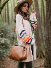 Beige knit duster cardigan with rainbow striped sleeves and a relaxed fit.