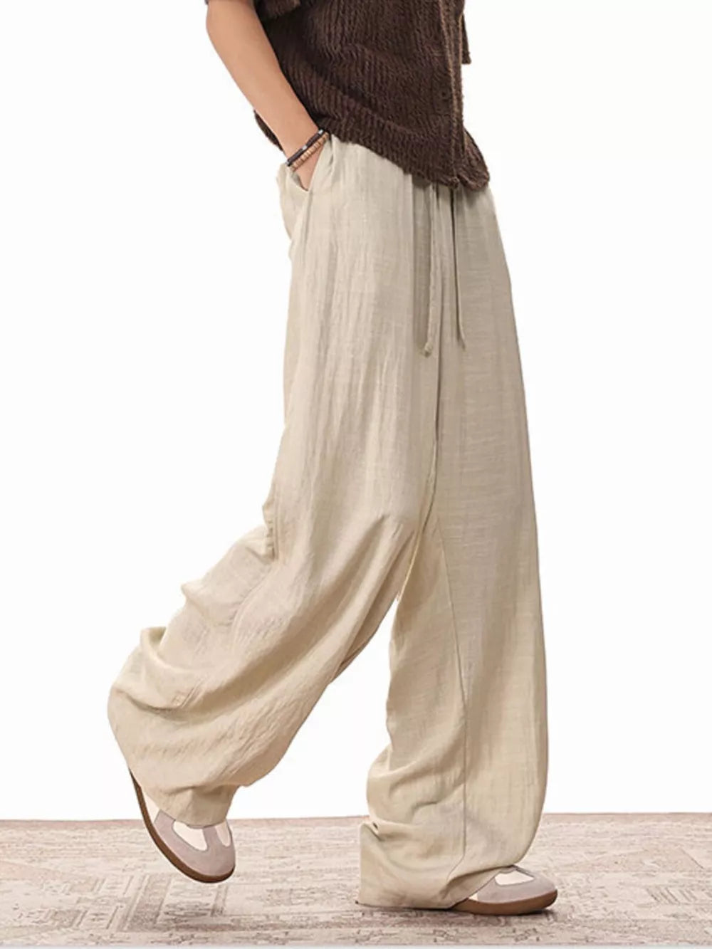Relaxed fit khaki drawstring sweatpants with pockets and wide legs.