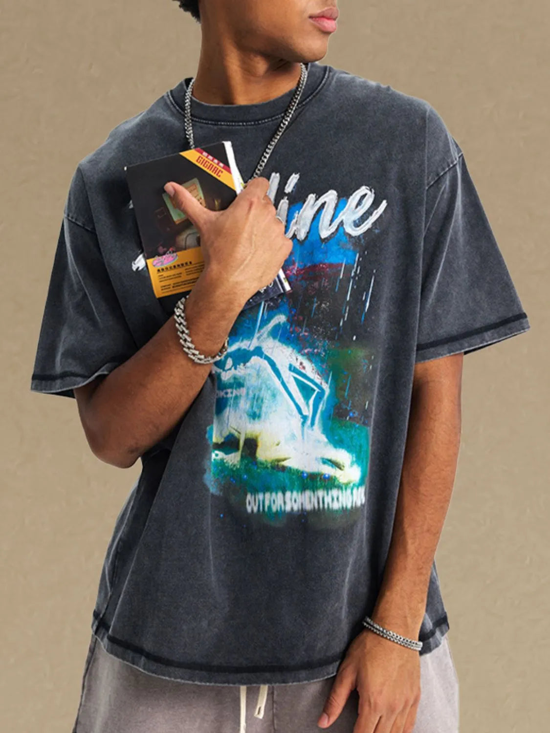GraphiSleeve acid-washed black crew neck t-shirt with graphic print and distressed details.