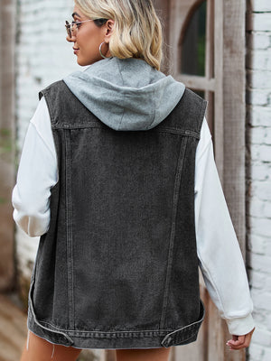 Black hooded denim vest with patch pockets, worn over a white hoodie.