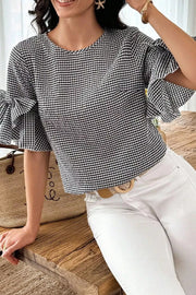 Black and white gingham polyester shirt with ruffled bow tie sleeves and a crew neck.