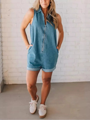 Denim romper with zipper closure, collared, sleeveless, cuffed shorts, and pockets.