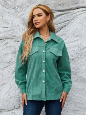 Textured corduroy button-up jacket in Peacock Green with two chest pockets and white buttons.
