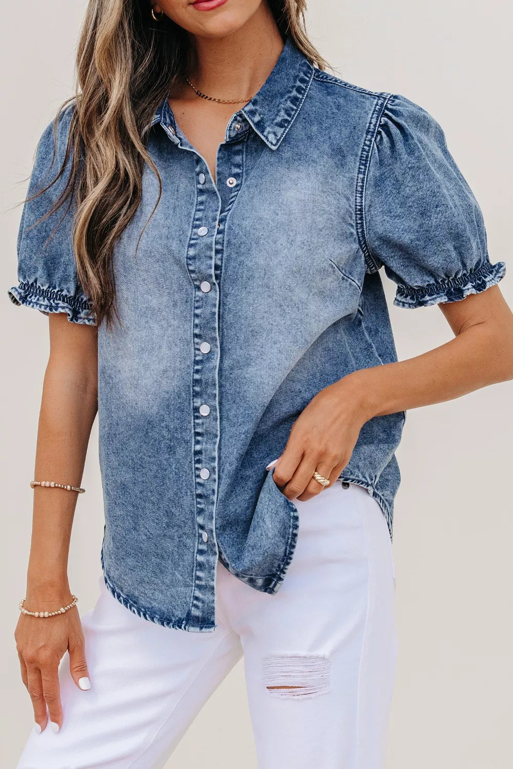 Denim shirt with puff sleeves and frilled cuffs, snap closure, collared neckline.