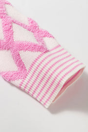 Diamond jacquard knit cardigan in blush pink with striped cuffs.