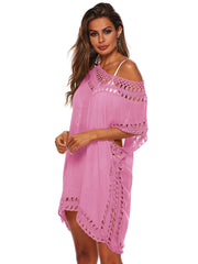 Pink kaftan cover-up with crochet trim and off-the-shoulder neckline.