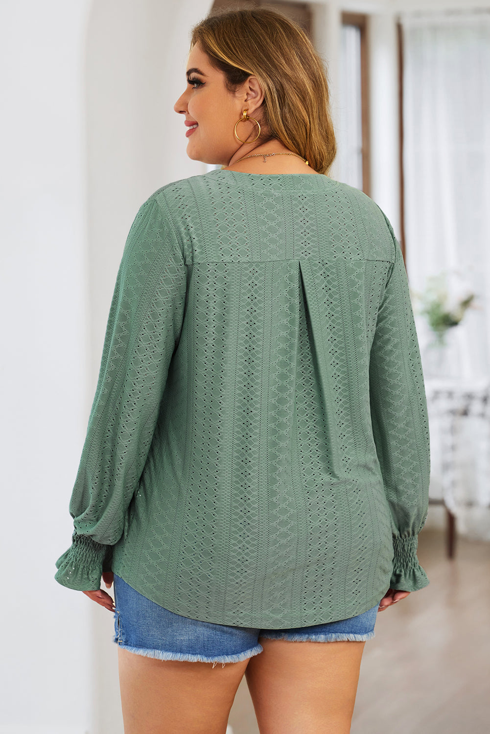 Sage green textured blouse with shirred cuffs and a slit-neck detail.