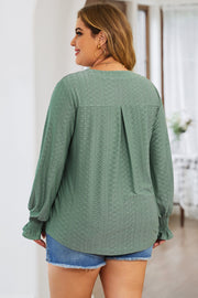 Sage green textured blouse with shirred cuffs and a slit-neck detail.