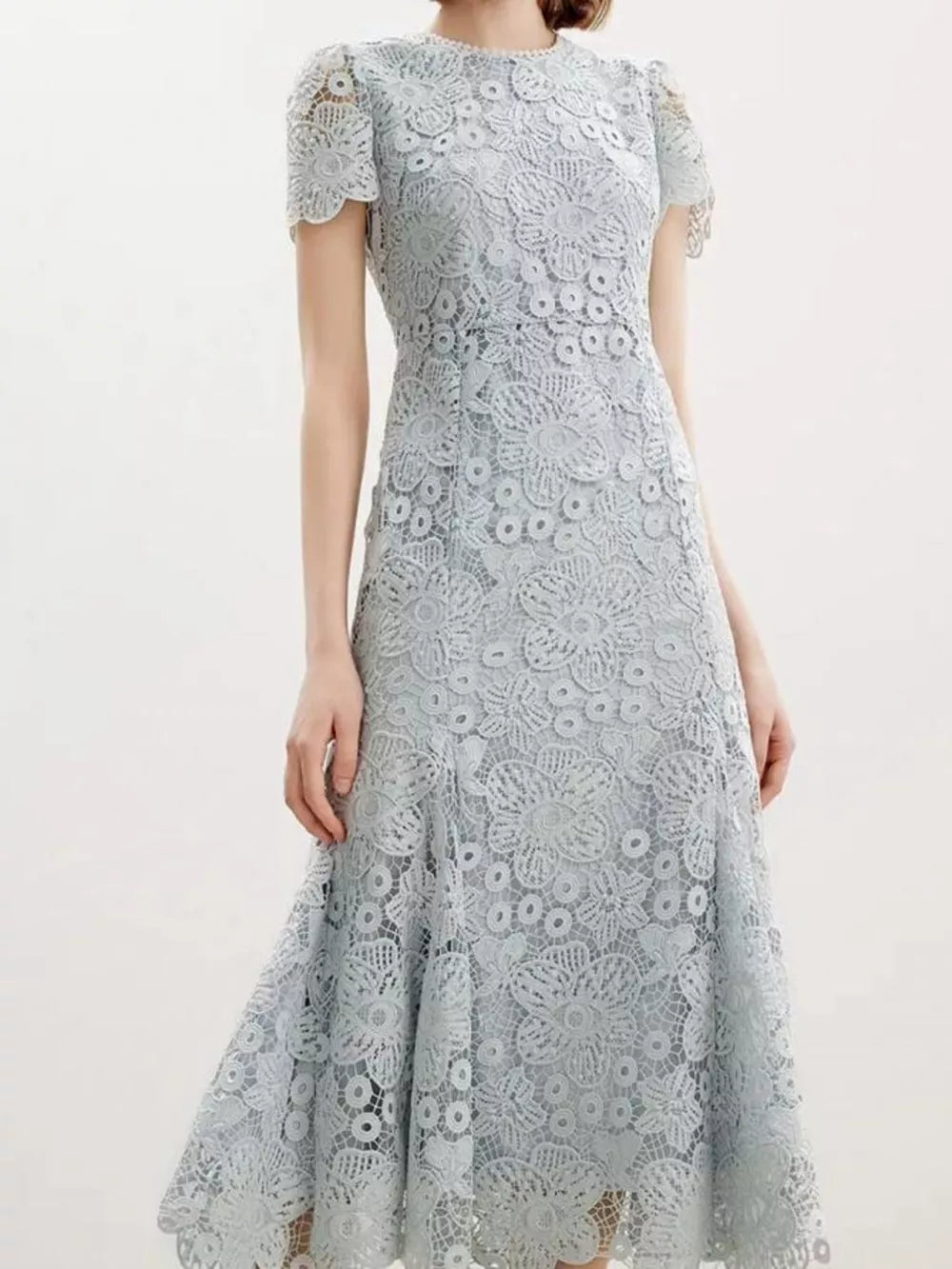 Light blue floral lace mermaid evening gown with cap sleeves and scalloped hem.
