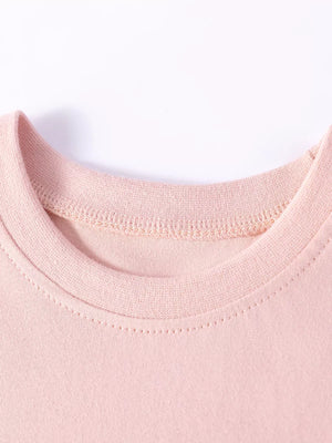 Children's pink cotton dress neckline with decorative stitching