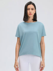 Relaxed fit performance tee in dusty blue with short sleeves and a boat neckline.