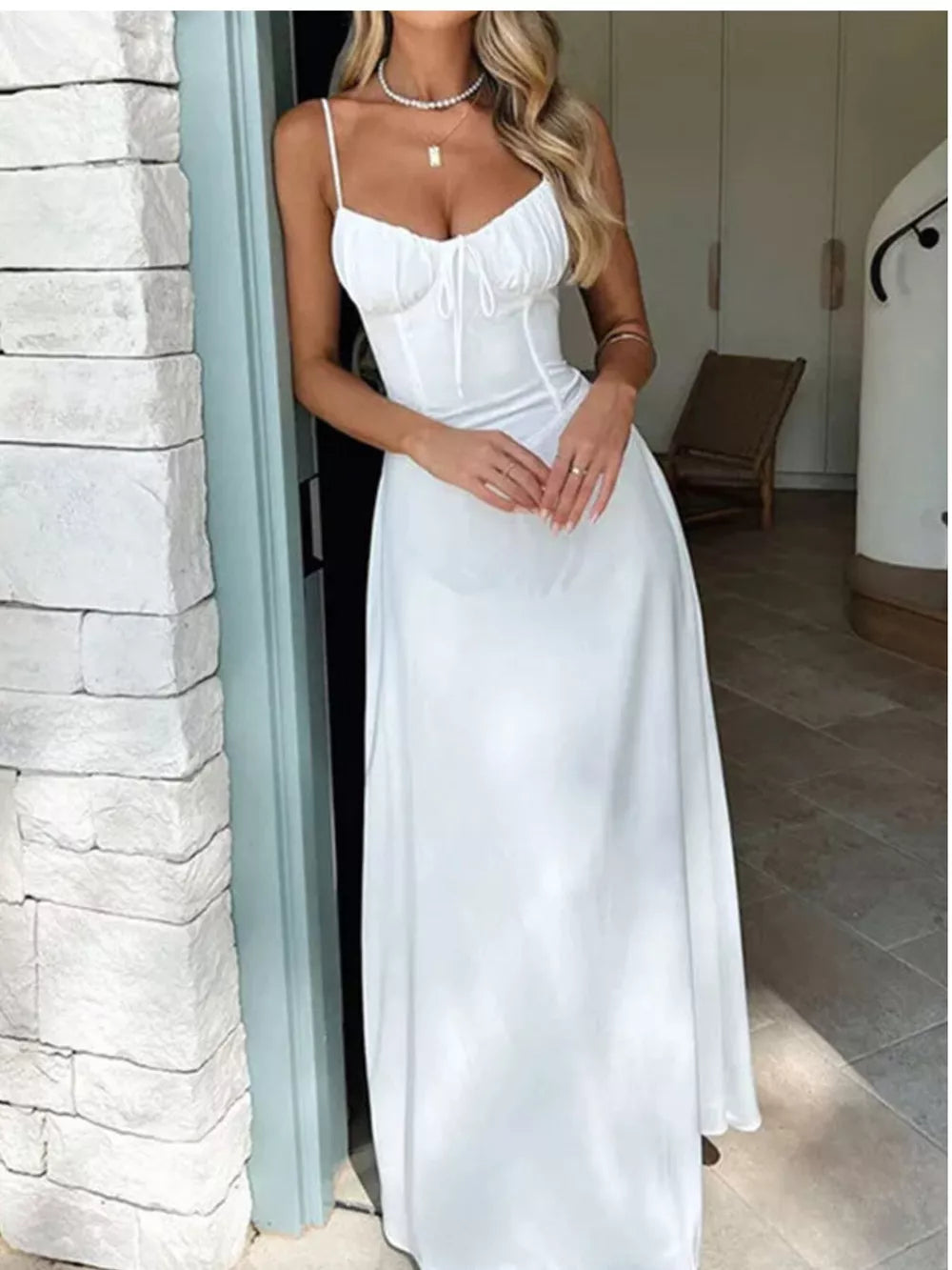 White tie-front maxi dress with spaghetti straps and ruched bodice detail.