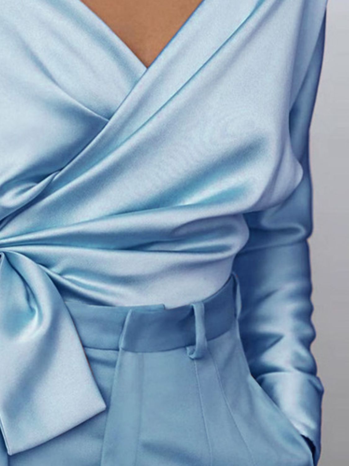 Light blue satin blouse with draped front and tie detail