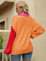 Colorblock drop shoulder knit sweater with orange body, red sleeves, and pink collar.