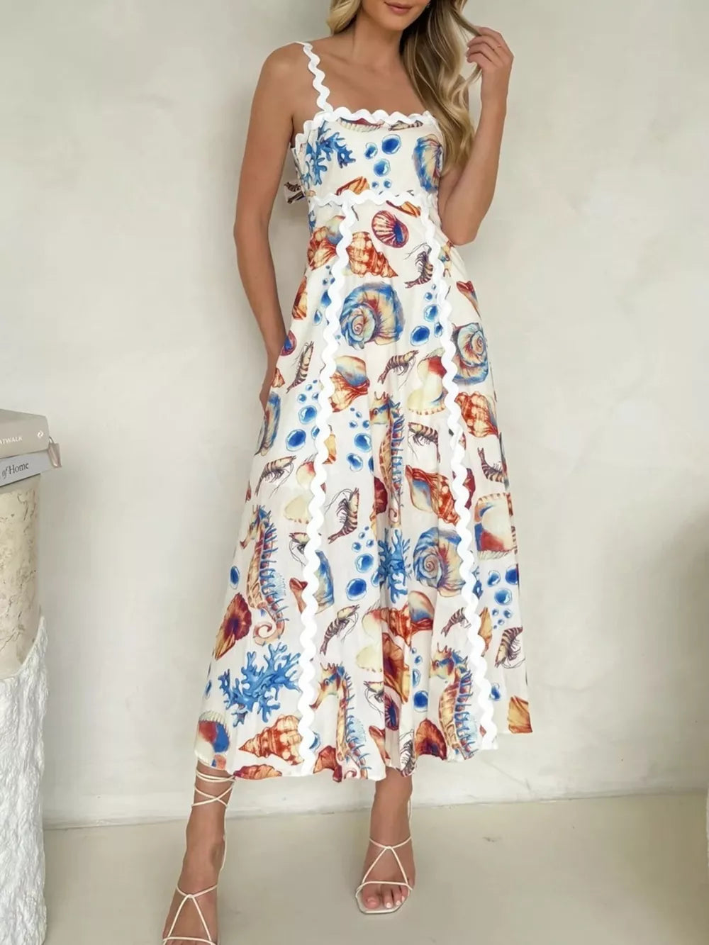 Midi dress with seashell print, scalloped trim, and square neckline.