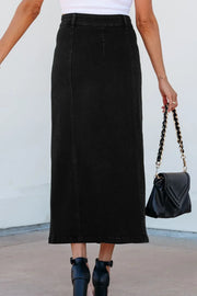 Black denim midi skirt with button front and side slit, styled with a black handbag.