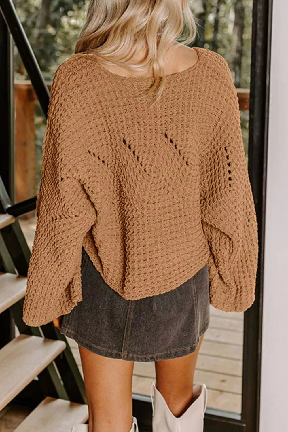 Brown textured knit sweater with wide bell sleeves and a scoop neck, styled with a denim skirt.