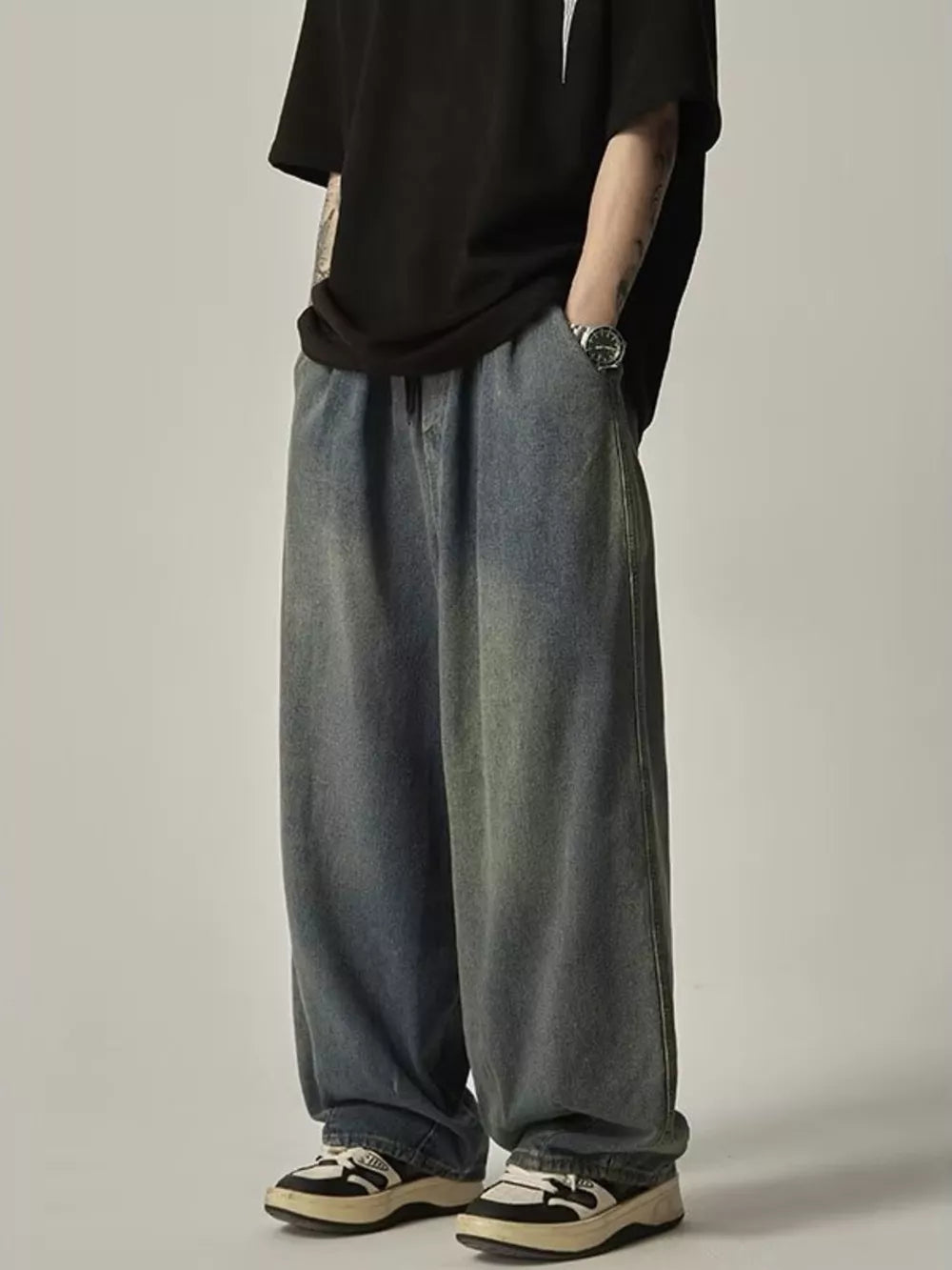 Relaxed fit blue vintage wash drawstring jeans with a wide leg