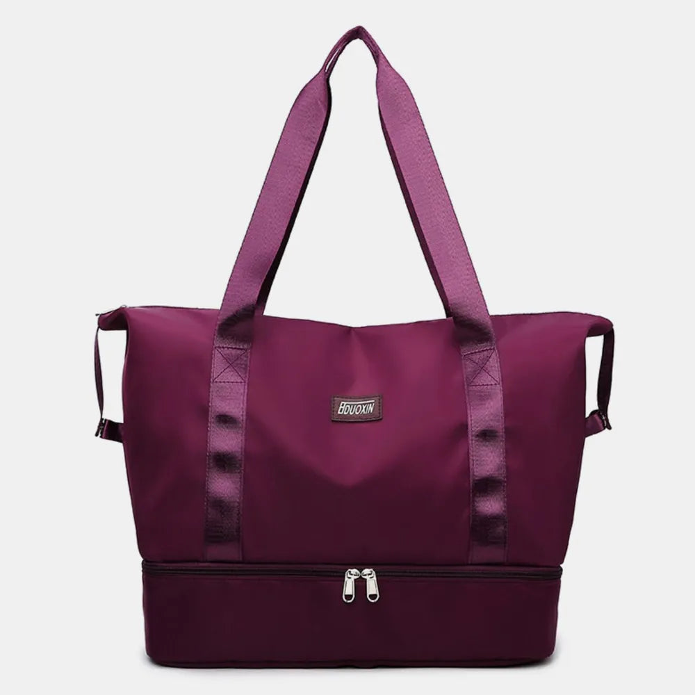 Plum purple dual-compartment travel tote with metallic trim and dual zippers.