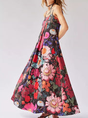 Vibrant floral maxi dress with gathered bodice and halter neck, featuring a bold botanical print.