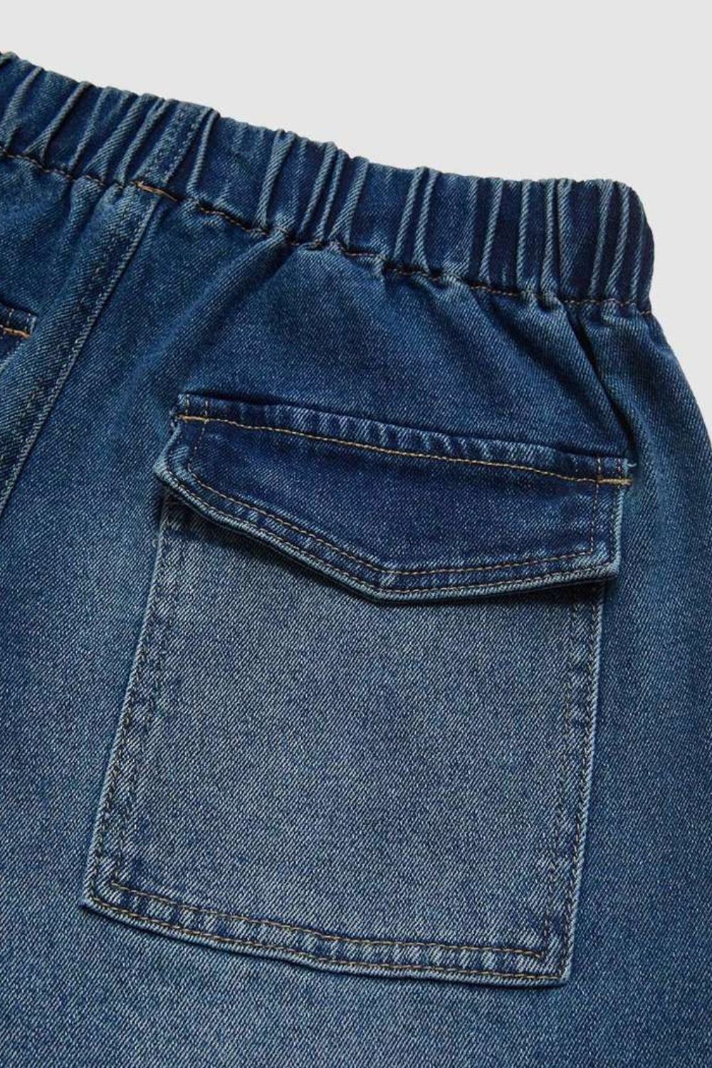 Elastic waist palazzo jeans in medium wash denim with a back patch pocket and contrast stitching.