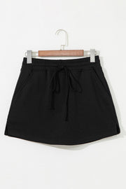 Black French terry drawstring skort with pockets and elastic waistband.