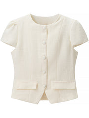Textured cream button-down top with short puff sleeves and pocket details.