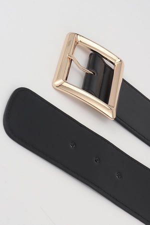 Black elastic belt with a gold sculptural buckle and adjustable snap closures.