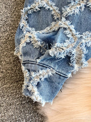 Distressed denim jacket and shorts set with frayed details and a light wash.